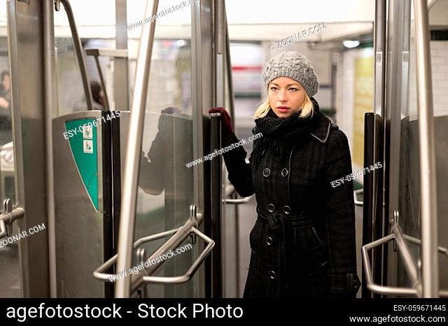 Beautiful blonde caucasian lady entering the metro station. Public transport