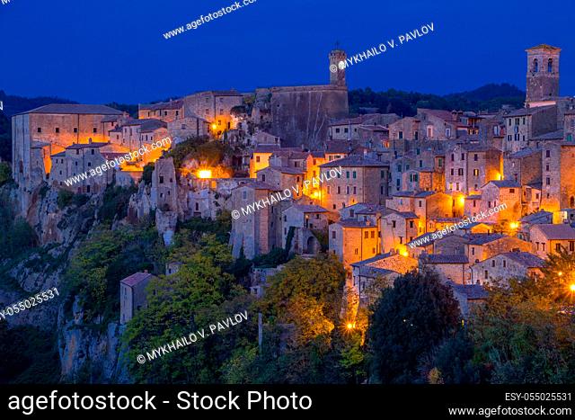 Italy. The old town of Pitigliano. Late summer evening. Stone walls and street lights
