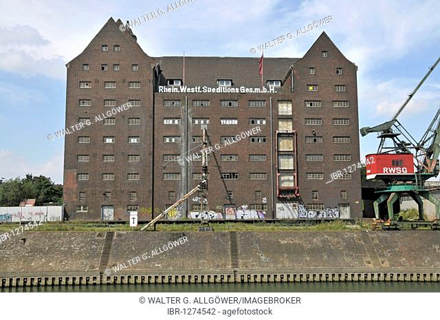 Disused RWSG warehouse and a harbor crane, future site of the State Archives of NRW, Inner Harbour, Duisburg, North Rhine-Westphalia, Germany, Europe