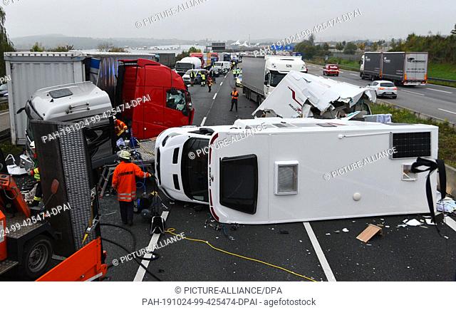 24 October 2019, Baden-Wuerttemberg, Sinsheim: Several destroyed vehicles lie and stand on the motorway. In an accident with four trucks and one car on the...