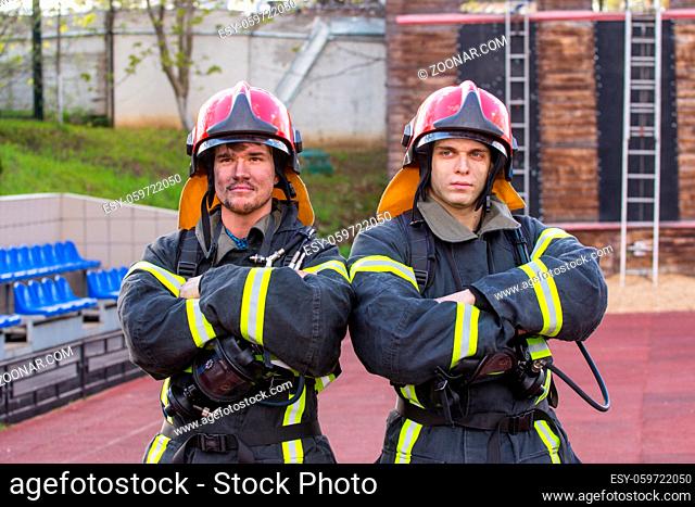 Portrait of two heroic fireman