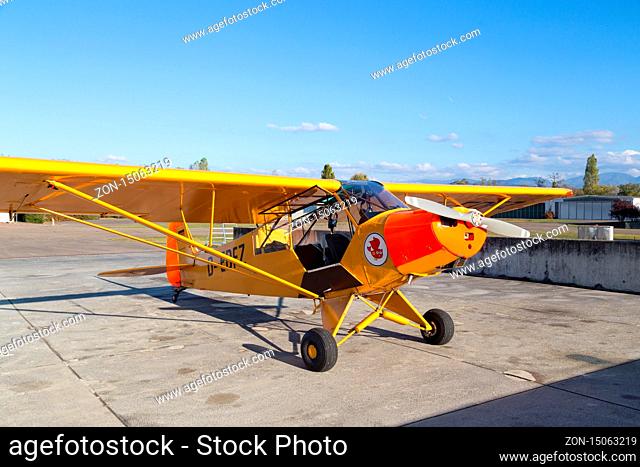 Bremgarten, Germany - October 22, 2016: A classic yellow Piper Cub aircraft parked at the airport