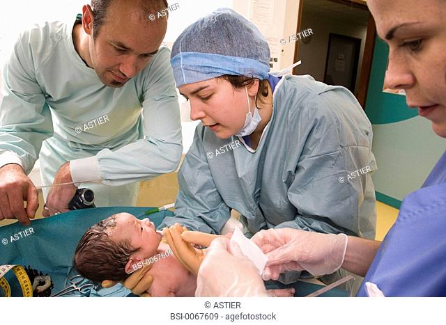 Photo essay at the maternity of Saint-Vincent de Paul hospital, Lille, France. The student midwife is administering vitamin K to the newborn baby