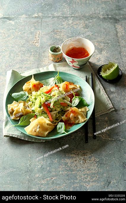 Wonton with shrimp filling on top with Chinese cabbage salad
