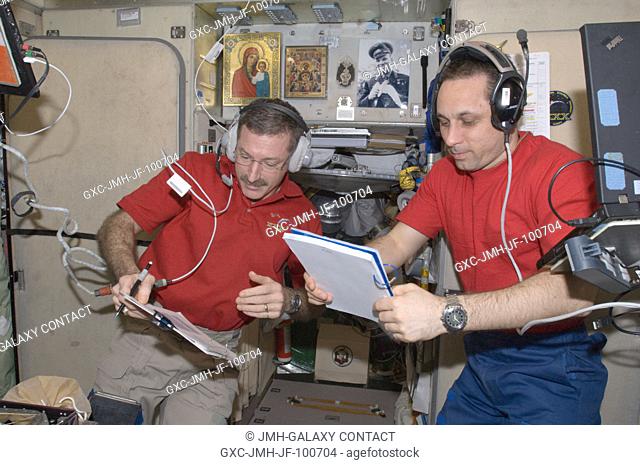 NASA astronaut Dan Burbank (left), Expedition 30 commander; and Russian cosmonaut Anton Shkaplerov, flight engineer, wearing communication headsets