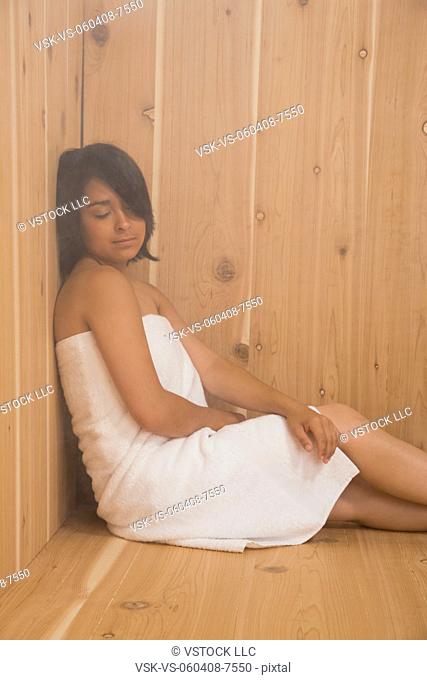 USA, Illinois, Metamora, Young woman relaxing in sauna