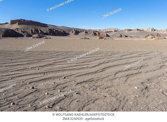 View of rock formations in the Valley of the Moon near San Pedro de Atacama in the Atacama Desert, northern Chile with sand in the foreground