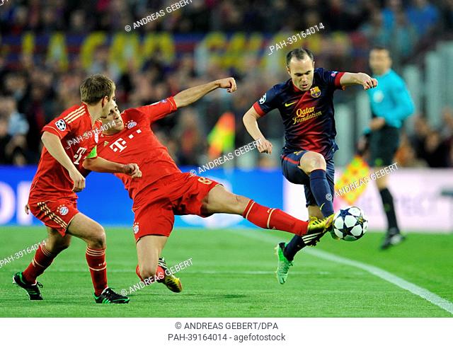 Barcelona's Andres Iniesta (R) and Munich's Javi Martinez (C) and Philipp Lahm vie for the ball during the UEFA Champions League semi final second leg soccer...