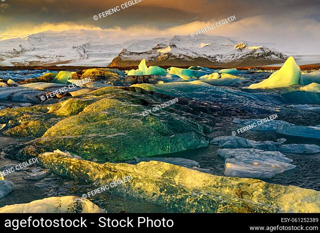 Ice floes in a dramatic sunset color on Jokulsarlon lake, - a famous glacier lagoon in Vatnajokull National Park, Iceland