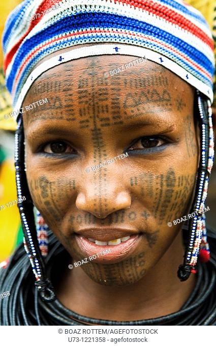 Portrait of a Peul / Fulani woman covered with traditional facial tattoos. photo taken in the Benin / Niger border area