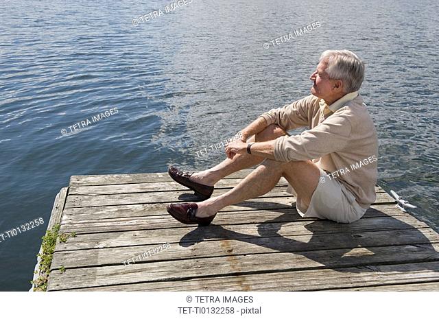 Senior man sitting on dock