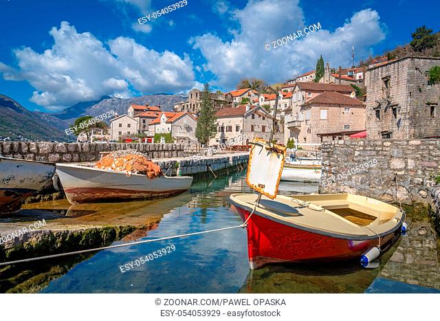 Anchored fishing boats on the shore in the beautiful Perast town in the Kotor Bay, Montenegro
