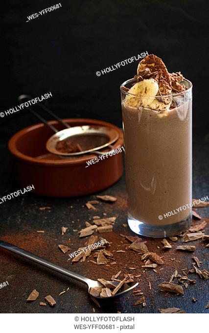 Glass of cocoa smoothie with banana, avocado, cocoa and chocolate chips