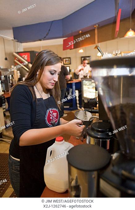 Alamosa, Colorado - An Americorps volunteer makes a drink at Milagros Coffee House  Profits from the coffee house support La Puente