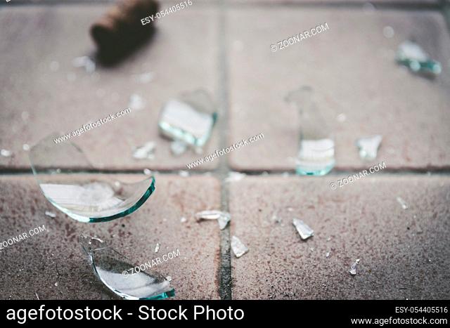 Piece of broken glass on the floor, wine bottle