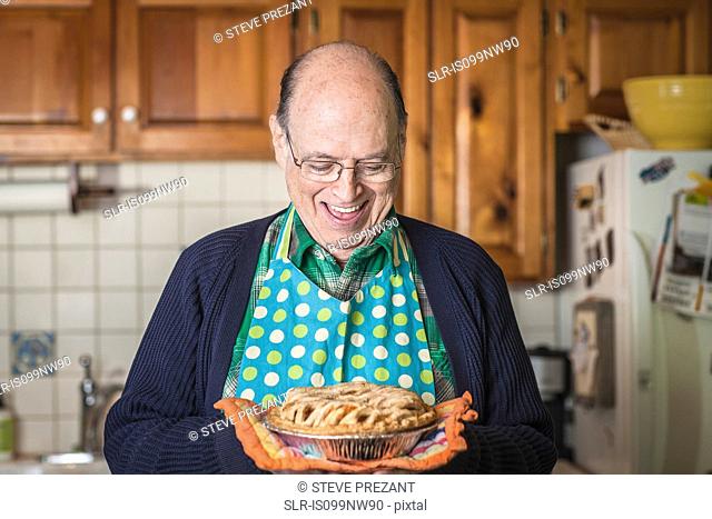 Senior man holding freshly baked pie