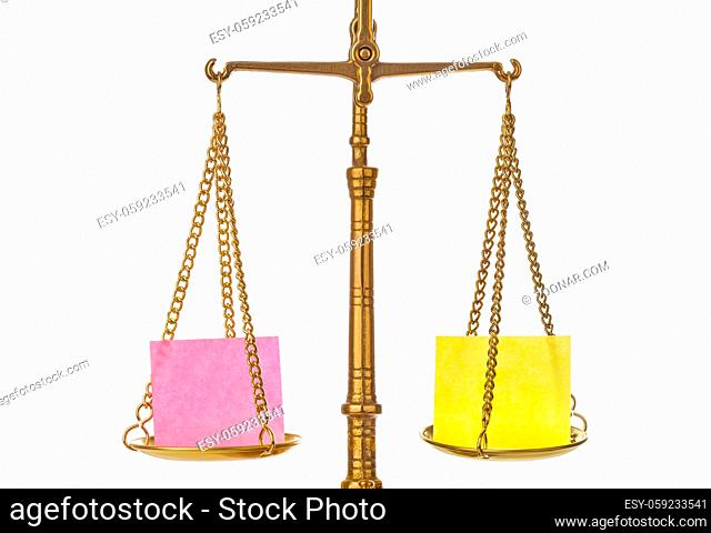 Golden weight balance scale with blank paper isolated on white background