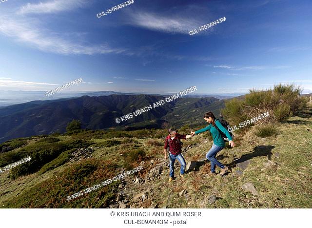 Hikers trekking on hilltop, Montseny, Barcelona, Catalonia, Spain
