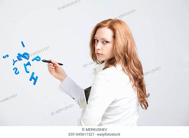 Young woman working with a set of letters, writing concept