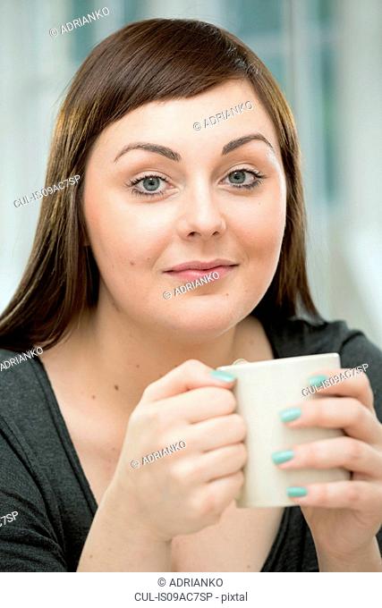 Young woman with a coffee cup