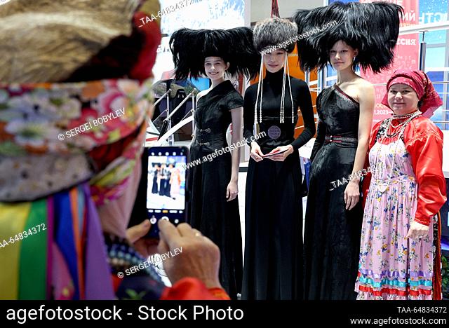RUSSIA, MOSCOW - NOVEMBER 15, 2023: Girls in fancy and traditional costumes are seen at the Buryatia display stand during the Russia Expo international...