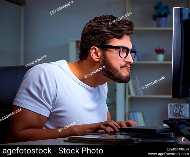 The young man staying late in office to do overtime work