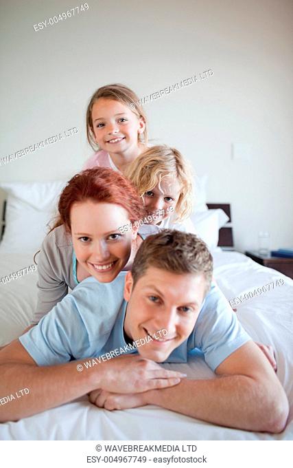 Playful family lying on each other