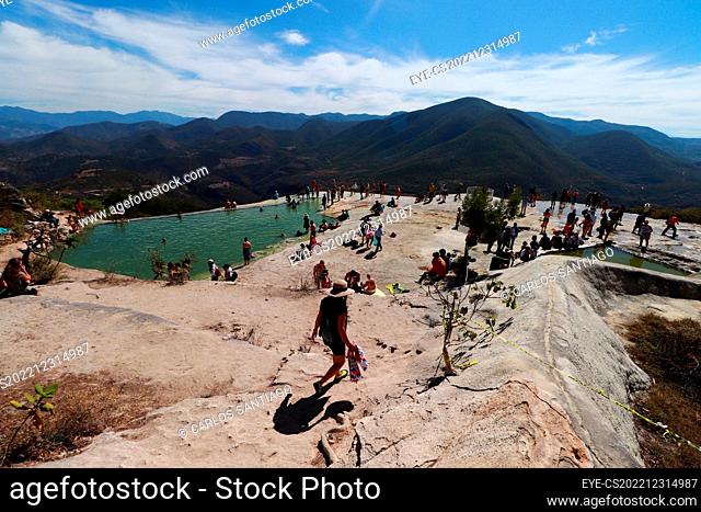 December 30, 2022 in Oaxaca, Mexico: Tourists enjoy the petrified waterfalls of Hierve el Agua, formed thousands of years ago by the runoff of water with a high...
