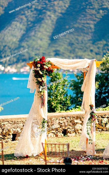 Wedding Arch on the beach. Wooden arch for the wedding ceremony of fabrics and colors in Perast, Montenegro