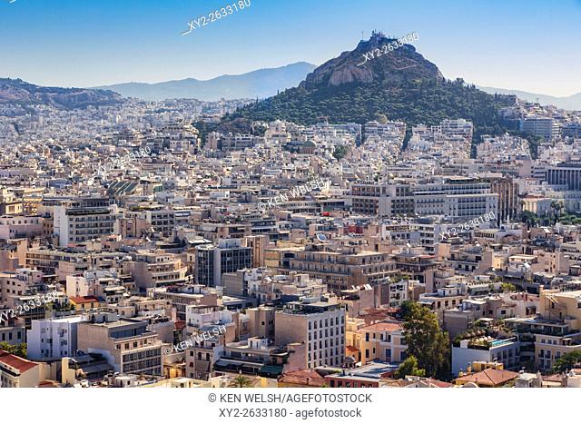 Athens, Attica, Greece. View over Athens from the Acropolis to 277 meter high Mount Lycabettus (Lycabettos or Lykabettos or Lykavittos) crowned by the Chapel of...
