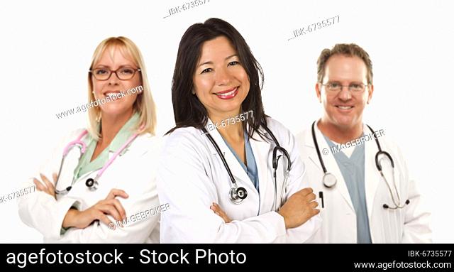 Friendly hispanic female doctor and colleagues before a white background