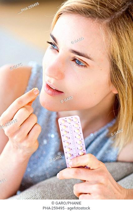 Woman holding contraceptive pills