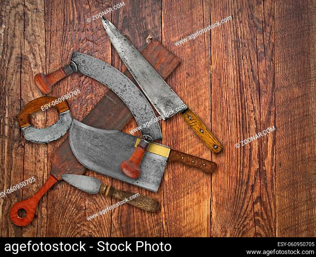 vintage kitchen knives and sharpening tools collage over old wooden table, space for your text