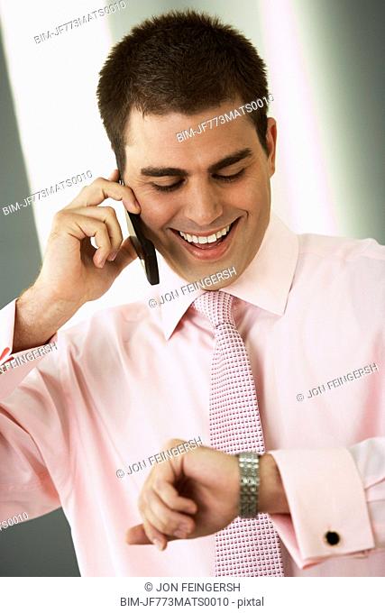 Middle Eastern businessman checking watch