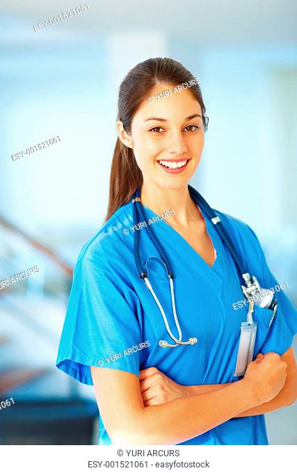 Confident female doctor smiling with hands folded