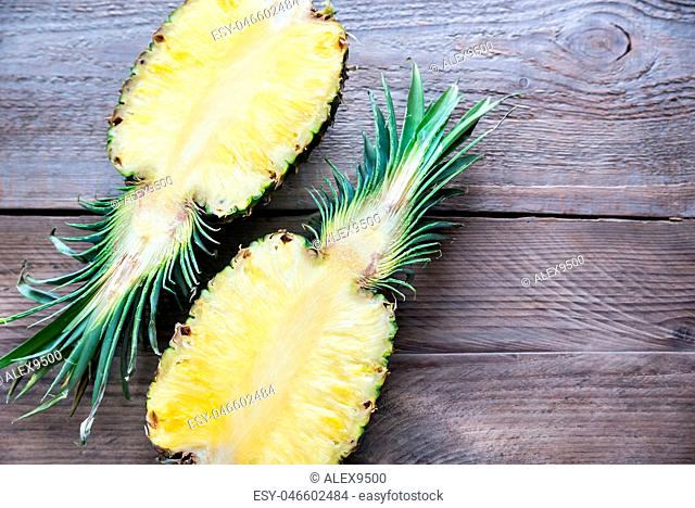 Pineapple on the wooden background: cross section