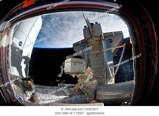 An Expedition 26 crew member used a fish-eye lens attached to an electronic still camera to capture this image of the docked space shuttle Discovery (STS-133)...