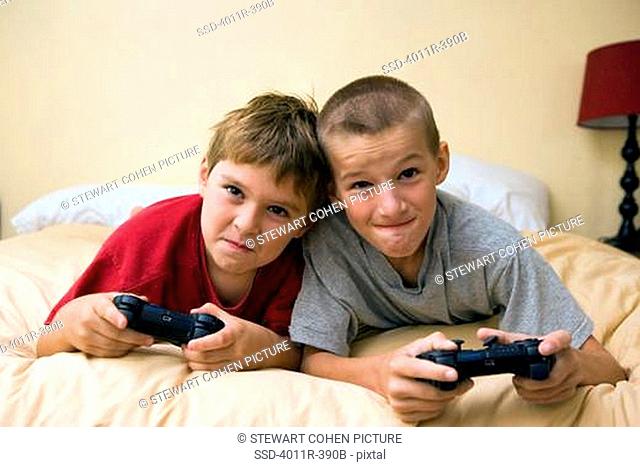 Two boys competing in a video game, Brazil