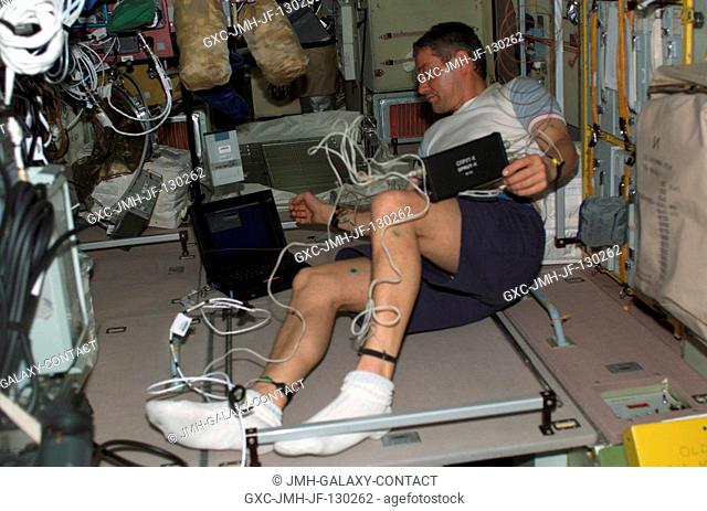 Cosmonaut Valery G. Korzun, Expedition Five mission commander representing Rosaviakosmos, works in the Zvezda Service Module on the International Space Station...