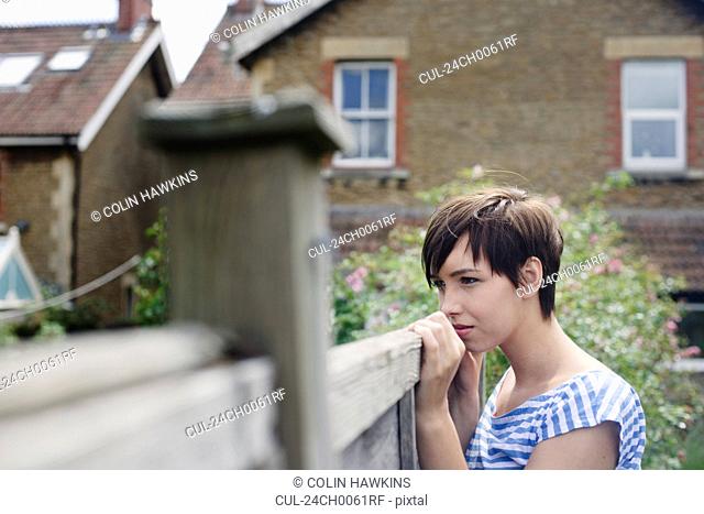 Woman looking over fence