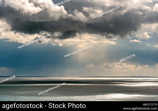 Stormy sky with dramatic clouds above the sea. Stormy weather at the ocean