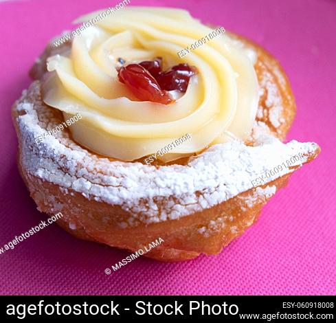 Zeppole of Saint Joseph, Italian pastry with flour, sugar, eggs, oil, decorated with a sour cherry. Father's Day cake