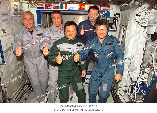 The crewmembers onboard the International Space Station (ISS) give a unified thumbs up signal while posing for a group photo in the Destiny laboratory following...