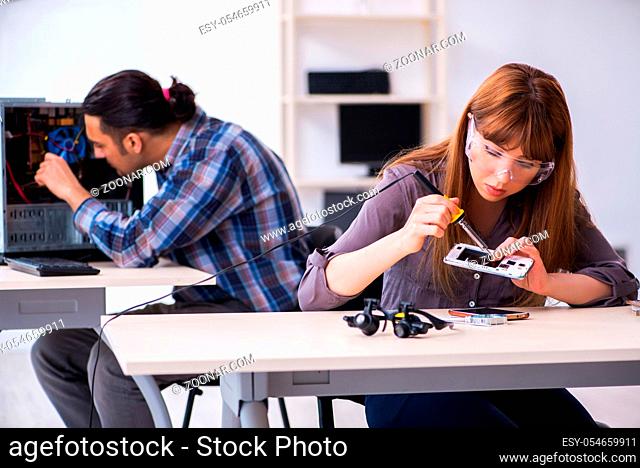 The two technicians working at computer warranty center