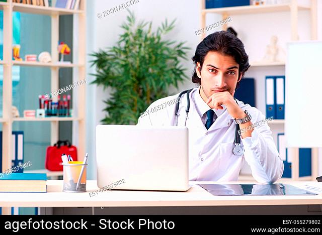Young handsome doctor working in clinic