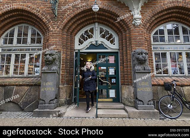 Hjorring, Denmark A woman exits the local apotek or pharmacy
