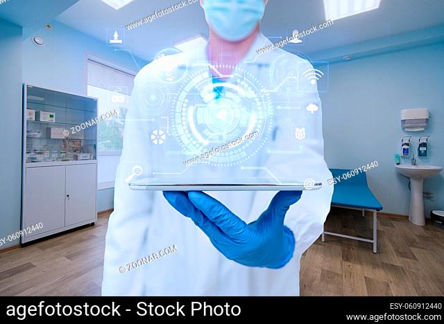 Doctor In The Laboratory Holding A Tablet Showing Futuristic Technology