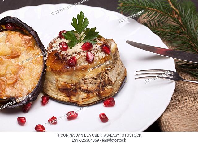 Plate with eggplant zuccotto, traditional dish of the Italian cuisine, prepared with eggplant, scamorza cheese and anchovies