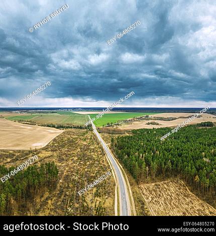 Aerial View Of Highway Road Through Deforestation Area Landscape. Green Pine Forest In Deforestation Zone. Top View Of Field And Forest Landscape