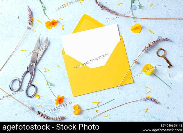 Summer invitation or greeting card stationery mockup with flowers, top flat lay shot. A Mother's Day or Women's Day design layout